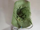 a green hat that is sitting on top of a table
