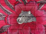 a large red and black flower with a leopard on it