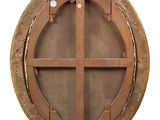 a wooden circular window on the side of a building