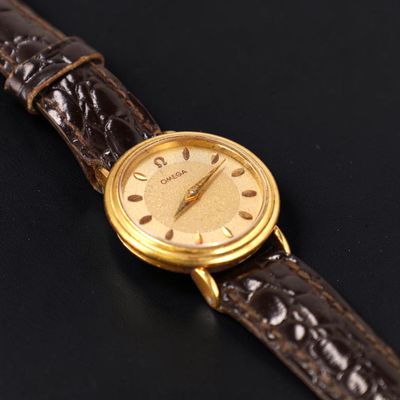 a close up of a wrist watch on a black surface