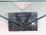 a glass table with a black and white marble top