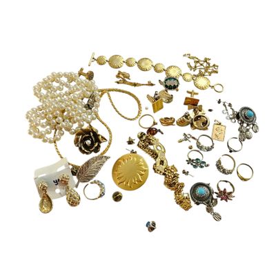 many different types of jewelry on a white surface