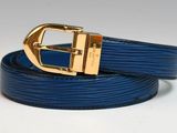 a close up of a blue belt with a gold buckle