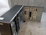 a computer that is sitting on the floor in front of a wall