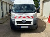 a white van parked in front of a building