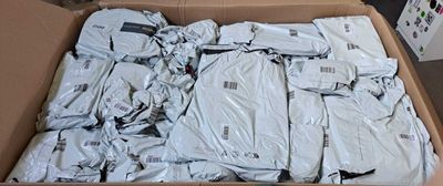 a cardboard box filled with a bunch of white shirts