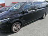 a picture of a black minivan parked in a parking lot