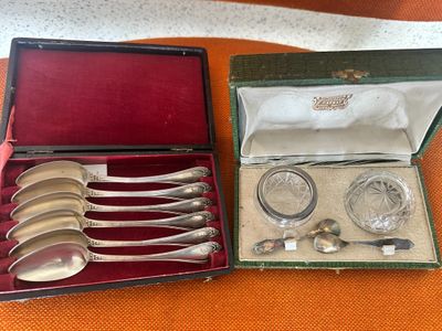 a box with silverware in it sitting on an orange cloth