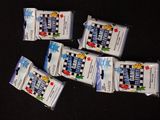 four packets of candy sitting on top of a black table