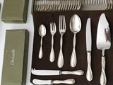 a set of silverware on a table next to a knife, fork, spoon and box