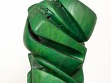 sculpture of a stack of green banana leaves sitting on top of a white pedestal
