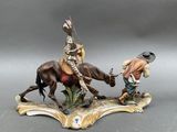 figurine of a man on a horse and a man on a horse