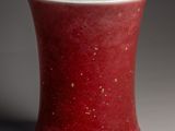 a red and white cup sitting on a table