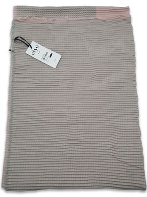 a gray and pink blanket with a tag on it