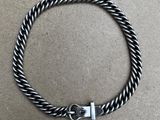 a black and white braid bracelet with a silver clasp