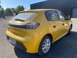 the rear end of a yellow car parked in a parking lot