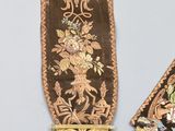 two pieces of cloth with a design of flowers and birds on them