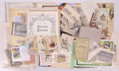 a pile of old books and postcards on a table
