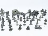 a lot of figurines that are on a white surface