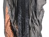 an image of a woman in a black dress and a black cape