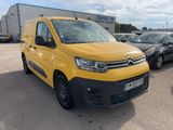 the yellow van is parked in the parking lot next to other cars
