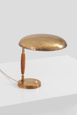 a close up of a table lamp on a white surface