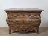 an antique chest of drawers with a marble top on a wooden floor