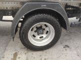 a truck with a flat tire parked on the side of the road