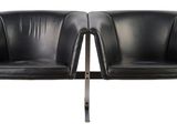 pair of black leather chairs with chrome legs on a white background