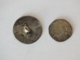 pair of antique silver buttons on a white surface