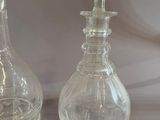 two glass vases that are sitting on a table
