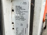 a close up of a parking meter with a sticker on it