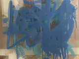 a blue piece of art that is sitting on the floor