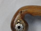 a close up of a wooden walking stick with a metal star on it