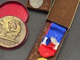 three medals sitting in a small box on a table