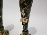 two vases that are sitting on a table