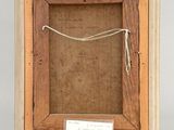 an old picture frame with a piece of paper and a note in it