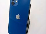 an apple iphone sitting on top of a stand on a white surface