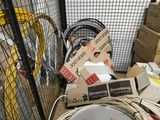 a toilet in the middle of a room filled with boxes and wires