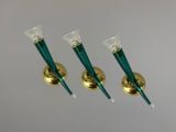 three green glass candlesticks with gold bases on a white background