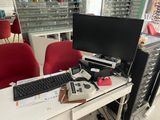 a desk with a computer, keyboard, and monitor on it