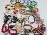 a pile of assorted necklaces and bracelets on a table
