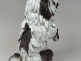 a figurine of a dog sitting on its hind legs