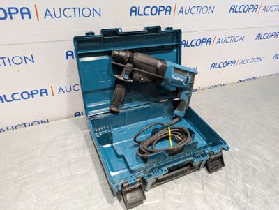 an electric drill in a blue case with a cord in it