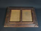 an old wooden window with two glass panes on top of it