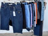 several pairs of jeans hanging on a rack in a clothing store