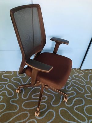 a brown office chair with a brown seat on a carpet