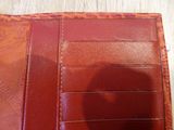 someone is taking a picture of their wallet with their cell phone