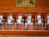 a wooden case with a number of glass jars on it