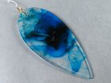 an image of a close up of a necklace with a blue flower on it